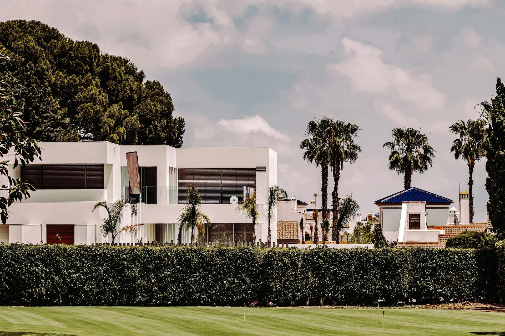 white concrete building near green grass field during daytime