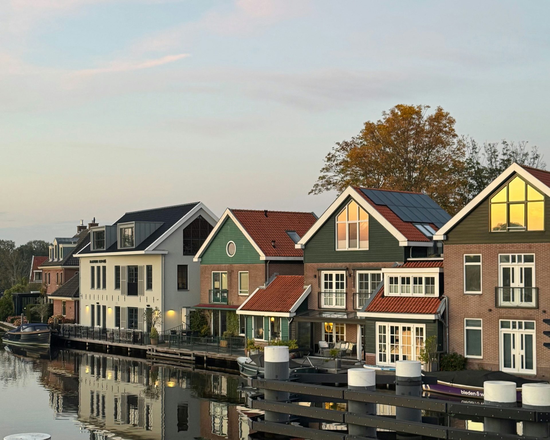 Row of houses along a canal at dusk.
